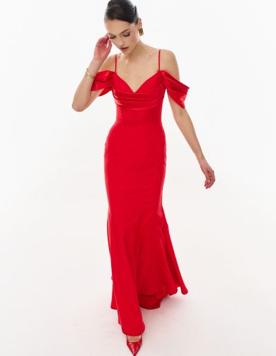 Red off the shoulder fit and flare evening gown in crepe satin, offered at Papilio Boutique.