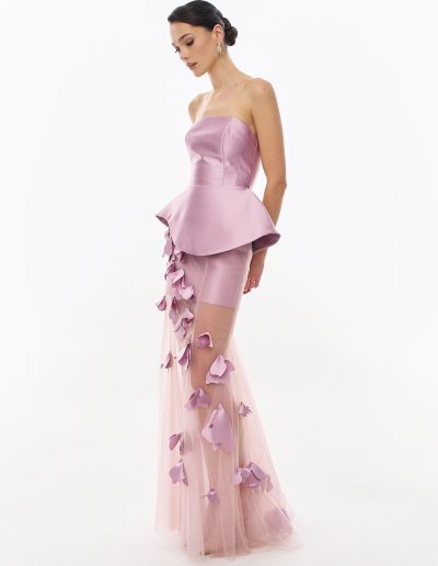 Side view of peplum corset evening dress with sheer floral overskirt offered at Papilio Boutique.