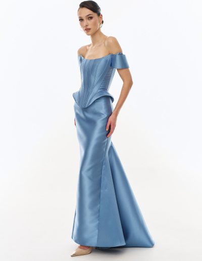 Angled front view of structured off the shoulder corset gown with fit and flare skirt offered at Papilio Boutique.