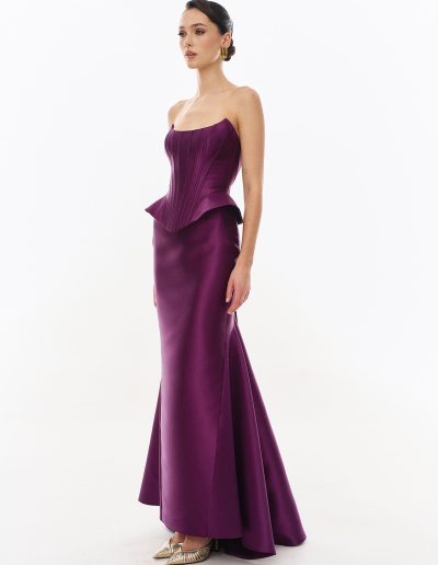 Side view of mikado peplum corset dress with structured bodice offered at Papilio Boutique.