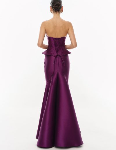 Back view of mikado peplum corset dress with lace-up detail offered at Papilio Boutique.