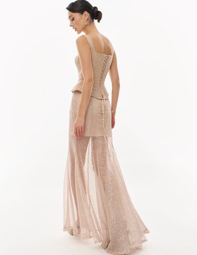 ): Back view of sequined corset evening dress with lace-up detail offered at Papilio Boutique.