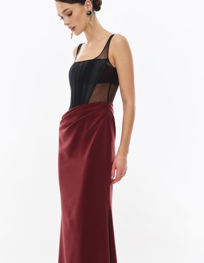 Close angled view of illusion corset bodice with draped skirt offered at Papilio Boutique.