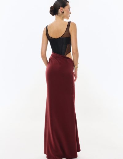 Back view of corset evening dress with draped silk skirt offered at Papilio Boutique.