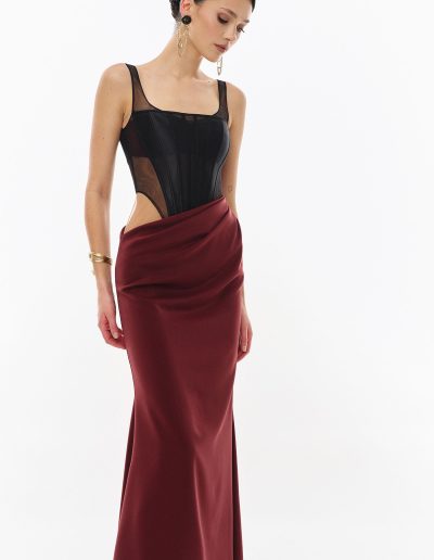 Close angled view of illusion corset bodice with draped skirt offered at Papilio Boutique.