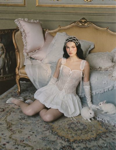 Bride wearing a lace bridal corset with ribbon ties and a bubble skirt at Papilio Boutique.