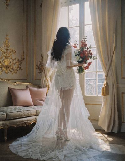 Bridal separates with sheer overlay featuring a semi-sheer lace corset, lace shorts and flowing tulle overlay at Papilio Boutique.