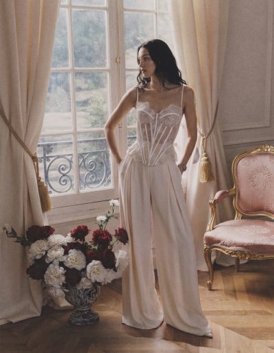 Modern bridal corset with pleated pants featuring a semi-sheer floral lace corset and wide-leg trousers at Papilio Boutique.